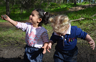Two year olds Alexandra and Layla immersed in our Mud Day explorations.